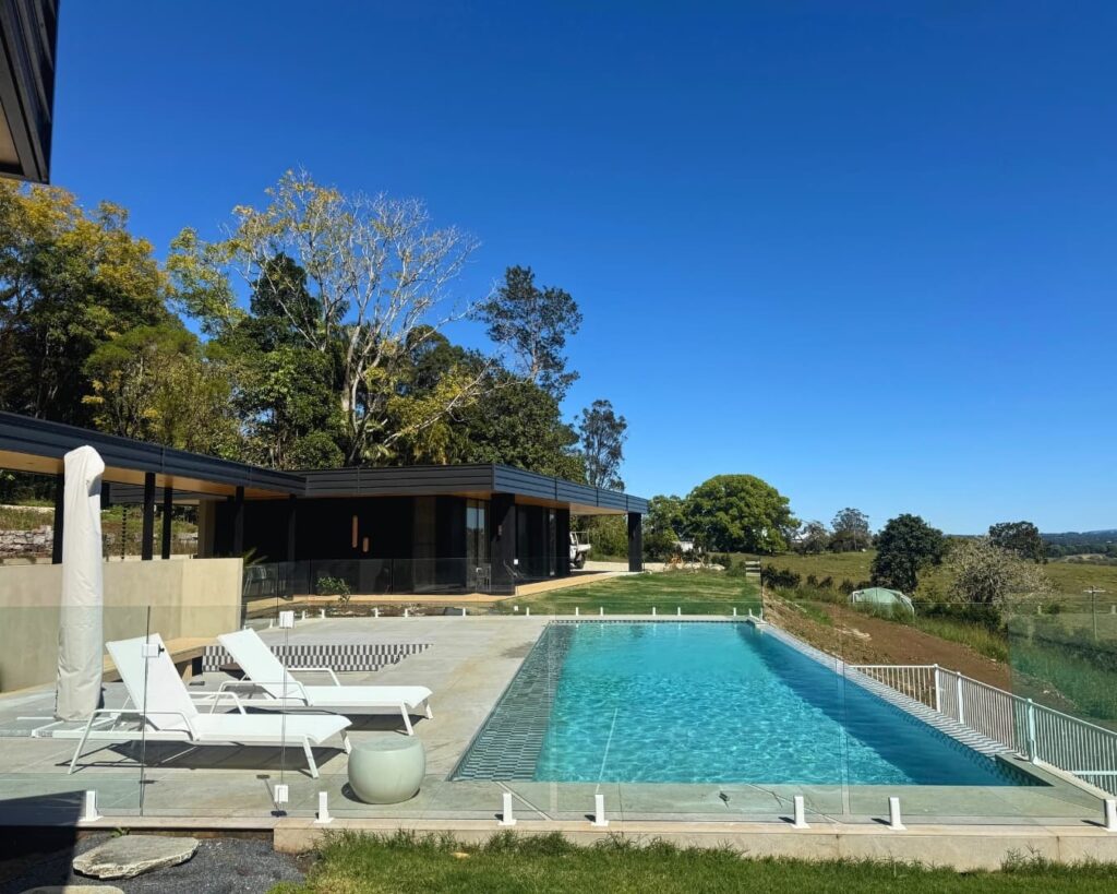 Custom concrete pool on a rural Byron Bay hinterland property with modern home and scenic surrounds