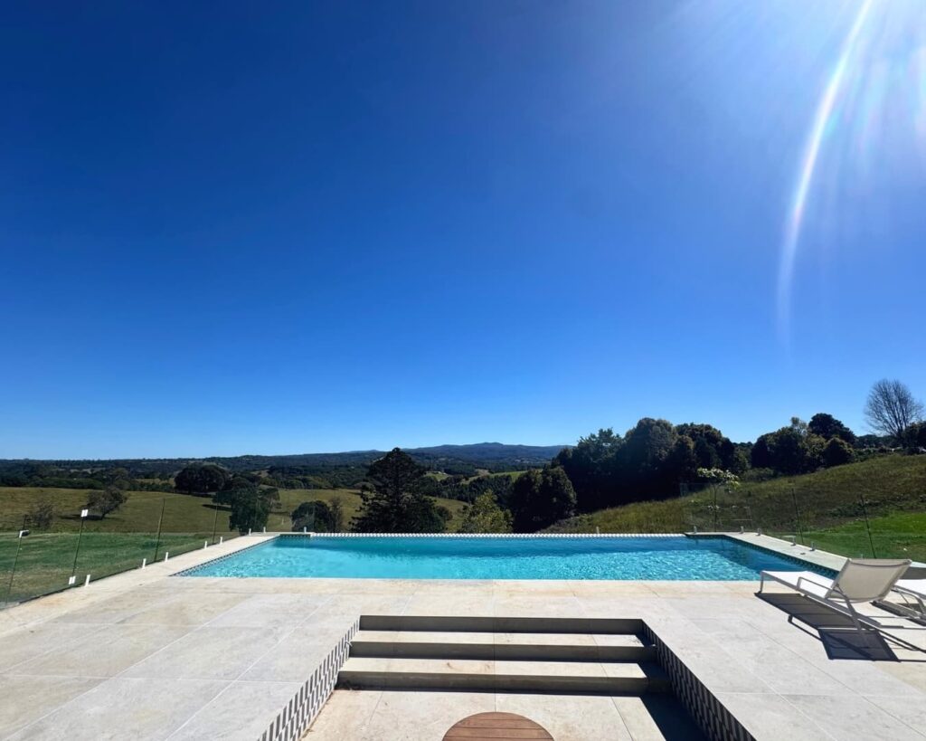 Modern concrete pool in the Northern Rivers hinterland with sunlit tiled surround and clear blue water